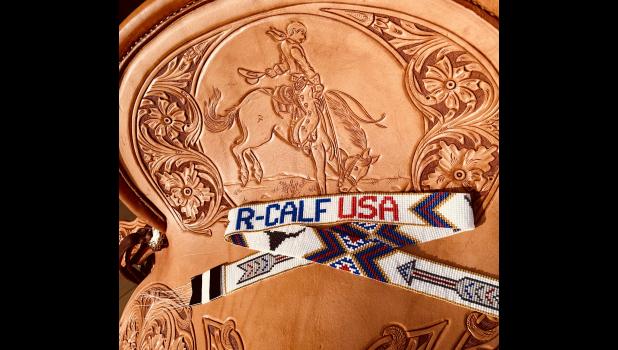 Hand-tooled bronc rider on the seat of the 2022 R-CALF saddle. Brianna Badure