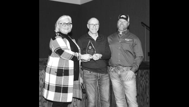 Cheryl Walker, left, was honored by West River Electric Assoc. CEO Dick Johnson, middle, and board president Andy Moon on Jan. 5, at a dinner at the Wall Community Center for her. Walker worked for 17 years at the coop, starting in 2005. She was recently the IT Specialist at WREA. Prior to her employment there, she was a teacher for 23 years in the Wall School District.