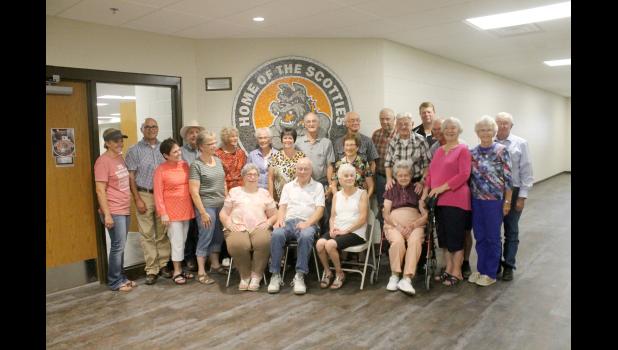 Gaylord “Guy” Paulson, sitting center, created the ceramic mosaic now permanently mounted to the new school building’s wall just outside the north entrance of the cafeteria. Many attended the unveiling of the artwork, including some fellow Philip High School Class of 1955 classmates. Del Bartels