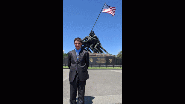 Carson Daly proudly stands in front of the National Marine Corps Memorial.