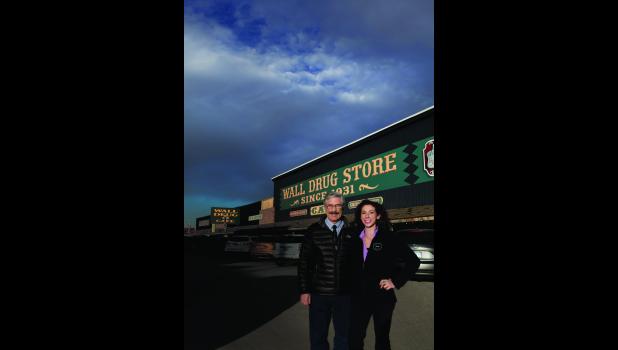 Rick Hustead and Sarah Hustead stand in front of the world famous Wall Drug Store. Photos are by Rodger Slott with Flashbox Photography