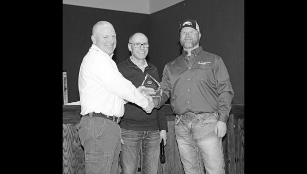 Wayne Shull, far left, was honored for his 38 plus years of employment with West River Electric. Shull retires Jan. 12 and was presented with an award by WREA CEO Dick Johnson, middle, and board president Andy Moon Jan. 5 at a special dinner honoring him and co-worker Cheryl Walker who also retired. Wayne was the Operations Superintendent for the Wall area office.